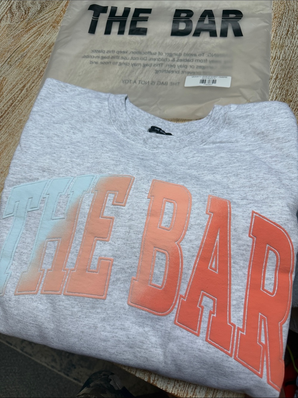 The Bar Light Gray Sweatshirt with Pastel Blue and Peach Logo